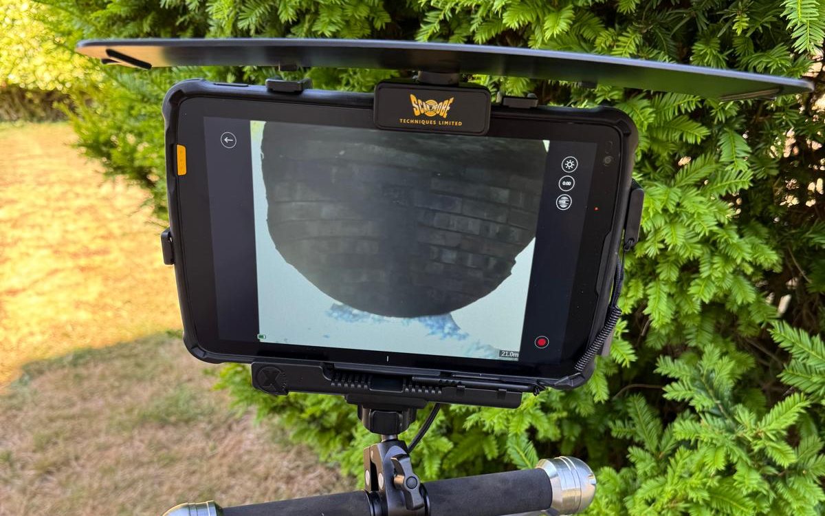 CCTV monitor on a survey reel showing live footage of underground brickwork during a Flowcraft drainage inspection